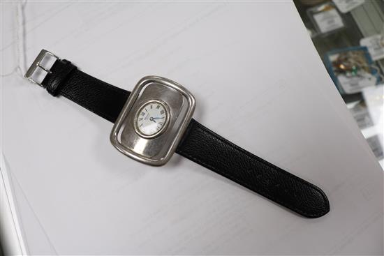 A silver Chopard Geneve manual wind buckle wrist watch.